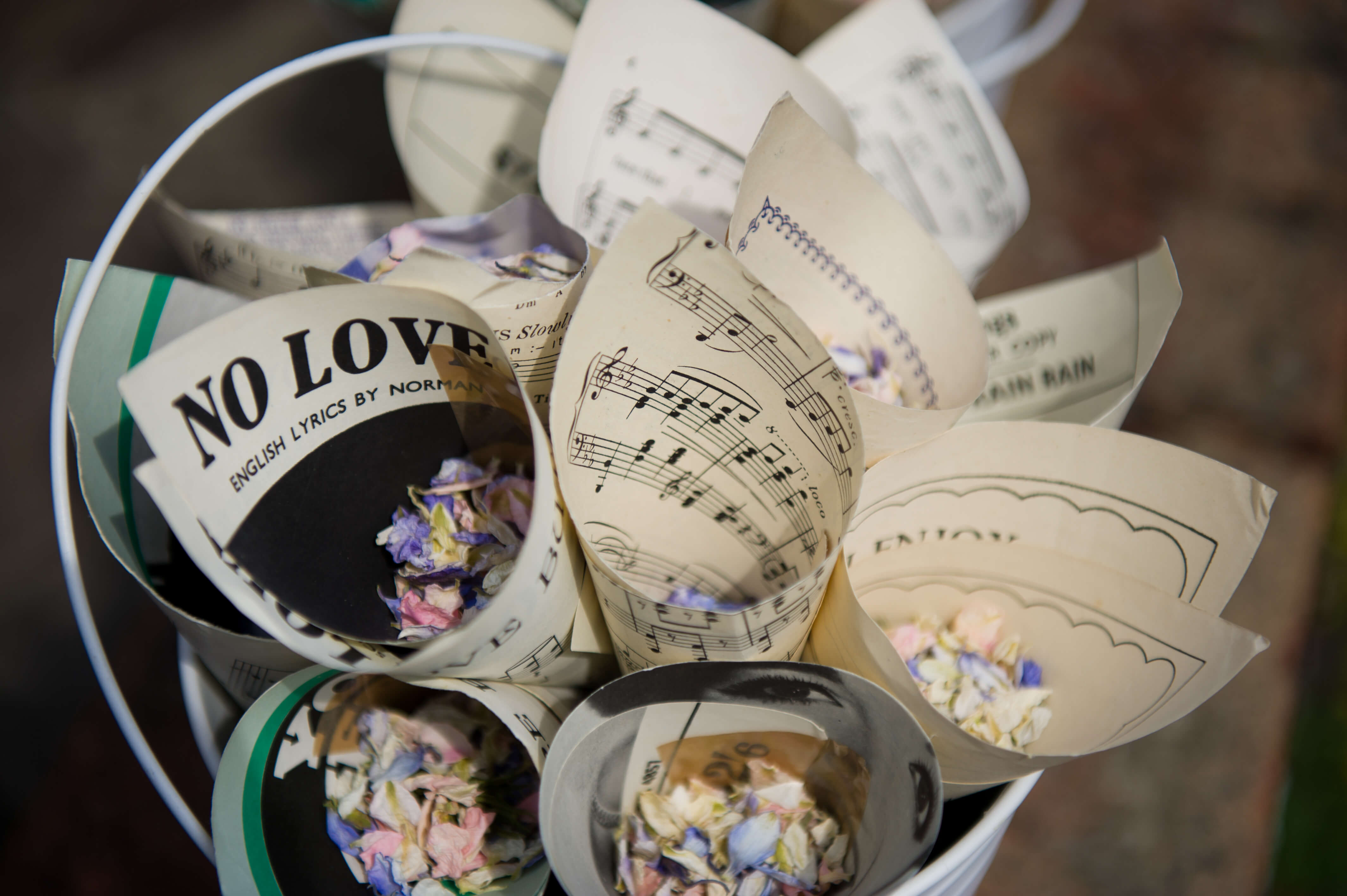 Dried flower confetti in cones of sheet music